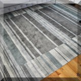 DR08. Wool green and gray striped rug. Measures approx 7'6” x 9'9” 